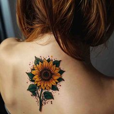 a woman with a sunflower tattoo on her back