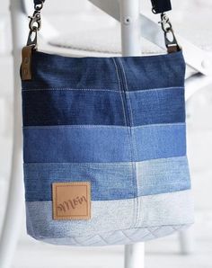 a blue and white striped purse sitting on top of a chair next to a brick wall