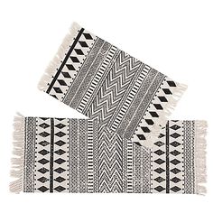 two black and white rugs sitting next to each other