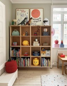 a child's playroom with bookshelves and toys on the shelves in it