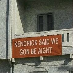 a sign on the side of a building that says, kentucky said we gon be alright