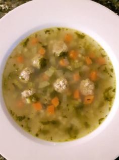 a white bowl filled with soup on top of a table