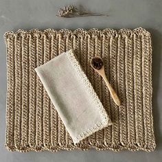 a wooden spoon sitting on top of a place mat