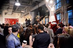 a large group of people standing in a room