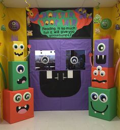 an entrance to a children's book store decorated in bright colors with monster faces