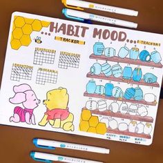 a winnie the pooh themed habitt mood planner with three pens and two pencils