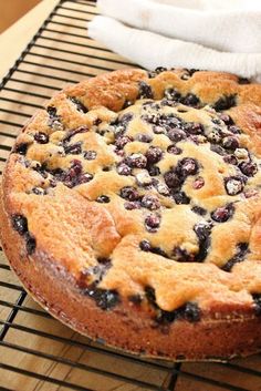 a blueberry pie sitting on top of a cooling rack