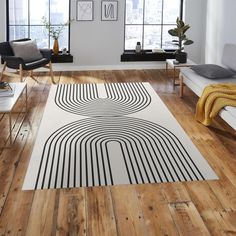 a living room with wooden floors and white walls