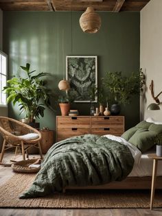 a bedroom with green walls and plants in the corner on the bed, next to a wicker chair