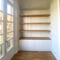 an empty room with some shelves in it