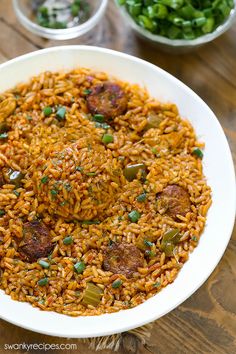 a white bowl filled with rice and meat