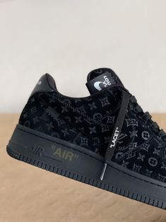 Embrace iconic style with these sneakers inspired by the legendary Louis Vuitton x Nike Air Force 1 Low. This all-black rendition exudes understated luxury, featuring the signature Louis Vuitton monogram subtly embossed on a premium leather upper. Off-White™-inspired details, like the quoted "AIR" branding and "LACET" tag, add a contemporary edge. Step into the spotlight with these coveted kicks that seamlessly blend high-fashion and streetwear culture. Your order arrives in a branded shoe box, Luxury Black Custom Sneakers With Embossed Logo, Luxury Black Custom Sneakers, Air Force 1 Noir, Luxury Custom Black Sneakers For Streetwear, Luxury Black Nike Air Force 1 Lace-up, Luxury Black Low-top Sneakers, Fall Winter Jacket, Baskets Nike, Nike Air Force 1