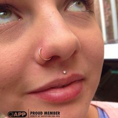 a close up of a person with a nose piercing