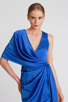 PRODUCT DETAILS Make way for a royal blue stunner in soft, flowy satin. This stunning dress is minimal in aesthetic and modern in execution. It's crafted for a draped silhouette—while keeping a perfectly structured finish to complement the body's natural shape. Back zipper One sleeve Wrap silhouette Waist-tie Draped detailing Midi length Satin back crepe 100% polyester Lined Dry clean 8816069 SIZE & FIT Side skirt length: 27.5" from waist to hem Model measurements: 5'10.5" tall Model is wearing Satin Cocktail Dress, In Aesthetic, High Hips, Jason Wu, Jewel Neck, Natural Shapes, Stunning Dresses, Three Quarter Sleeves, Waist Tie