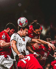 two soccer players colliding for the ball during a game