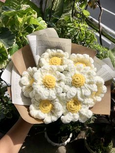 a bouquet of crocheted white and yellow flowers