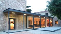 a modern house with glass walls and doors