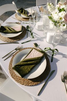 the table is set with place settings and napkins