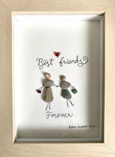 two people holding hands with the words best friends forever in front of them, framed in a wooden frame