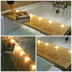 some candles are lit up in front of a bathtub with writing on the side