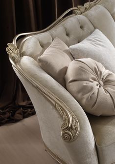 a white couch with some pillows on top of it