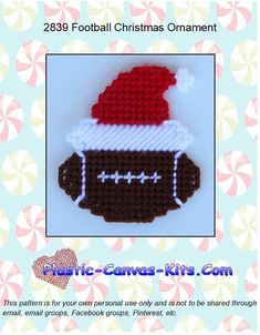 a crocheted christmas ornament with a football ball wearing a santa hat