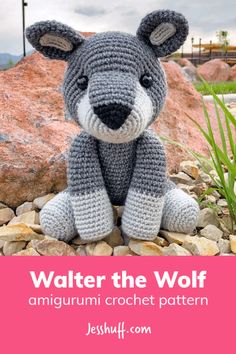 a crocheted stuffed animal sitting on top of rocks with the title walter the wolf amigurm crochet pattern