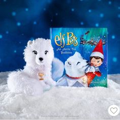 an elf's tale book and stuffed animal in the snow