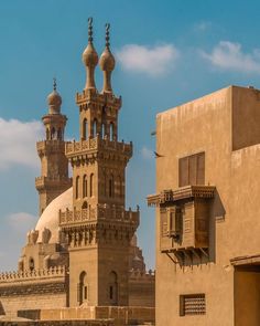 an old building with two towers on the top and another one in the back ground