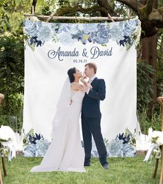 a newly married couple kissing in front of an outdoor wedding ceremony sign that reads amanda and david