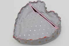 a heart shaped box with a pink handle