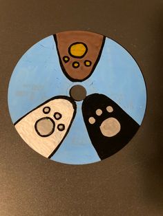 a circular painting with three different shapes on it