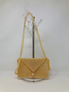 "This is an stunning little purse made completely of pearls! It's in perfect condition! Measurements: Length - 6.5\" Height - 4\" Strap - 18\" drop All of my items come from a smoke-free and pet-free home. If you have any questions, please don't hesitate to ask!" Gold Rectangular Bag With Pearl Material, Rectangular Gold Bag With Pearl Material, Gold Pearl Rectangular Evening Bag, Gold Rectangular Pearl Evening Bag, Rectangular Gold Pearl Bag, Rectangular Gold Pearl Evening Bag, Rectangular Gold Shoulder Bag With Pearl Embroidery, Gold Pearl Shoulder Bag For Wedding, Wedding Gold Pearl Shoulder Bag