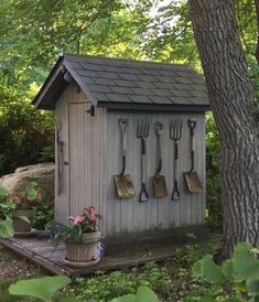 a garden shed with gardening utensils hanging on the wall