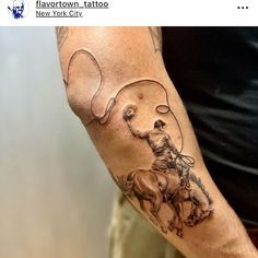 a man with a tattoo on his arm holding a horse and lasso in front of him