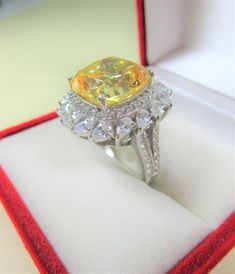 "LADIES CUSHION CUT YELLOW & PEAR CUT WHITE CUBIC ZIRCONIA RING Composition: White Gold over 925 Sterling Silver Cushion Cut Yellow CZ: Measures 13mm x 13mm x 9mm & approx. 11.75 carats in equivalent Diamond weight Color/Clarity: Vivid Yellow/IF-Internally Flawless. NOTE: Due to its perfect clarity & vast quantity of cuts the pictures are bouncing & reflecting light to the point that representative pictures have proved impossible to capture its brilliant quality. It is a much mor Ring Composition, Yellow Cushion, Silver Cushions, Yellow Cushions, Reflecting Light, Cubic Zirconia Rings, Multi Stone Ring, Jewelry Case, Multi Stone