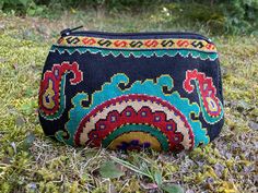 "Small Silk Petit Point Clutch, Handbag Organizer, Make Up Organizer created and handmade in Uzbekistan. Lined with silk and cotton fabric, zipper top.  Each clutch is hand drawn on to cotton canvas, inspired by original designs from Uzbekistan history.  Measures 6\"  high x 9\" width, 6.5\" opening  Embroidery the same on the front and the back of the clutch Can fit largest sizes of iPhone and Android. 100% silk petit point with handwoven silk and cotton lining. Your purchase preserves and enco Traditional Pouch For Everyday Use And Festivals, Traditional Pouch For Festivals, Traditional Pouch Coin Purse For Everyday Use, Traditional Rectangular Coin Purse For Daily Use, Traditional Black Pouch For Gift, Traditional Everyday Coin Purse Pouch, Traditional Bags With Woven Motifs For Gifting, Traditional Bags With Woven Motifs As Gifts, Traditional Embroidered Pouch For Daily Use