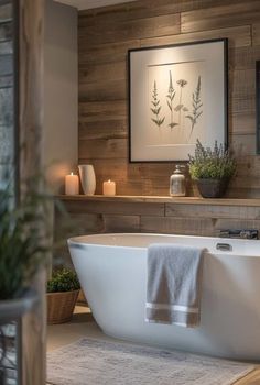 a white bath tub sitting in a bathroom next to a wooden wall and potted plants