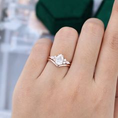 a woman's hand with a diamond ring on it