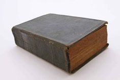 an old book sitting on top of a white table