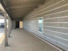 an empty building with wood siding and windows