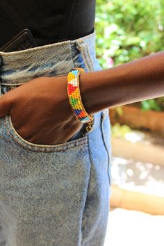 Handcrafted in Nairobi, Kenya, this Maasai inspired bracelet is crafted with faux leather and colored seed beads. Kindly note color of faux leather will vary from the picture and may not be brown as pictured.  A unique, different addition to your jewelry collection! Perfect for yourself or as a gift for a loved one! Length- 15 cm Comfortable to wear! Finished with a brass clap and chain. African Bracelets, Light Gold Color, Nairobi Kenya, Beaded Cuff Bracelet, Beaded Cuff, Maasai, Shades Of Gold, African Jewelry, Gorgeous Bracelet