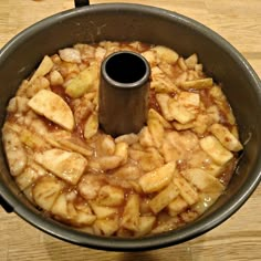 a pan filled with food on top of a wooden table