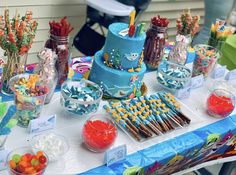 a table topped with lots of candy and cakes