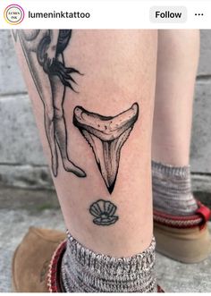 a woman's leg with tattoos on it and an image of a banana in the middle