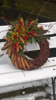 a wreath sitting on top of a white bench