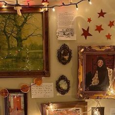 there are many pictures on the wall with lights strung from them and decorations around it