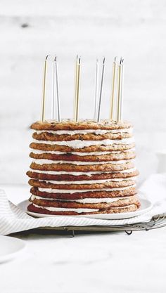 a stack of pancakes with candles on top