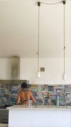 a man standing in front of a kitchen counter