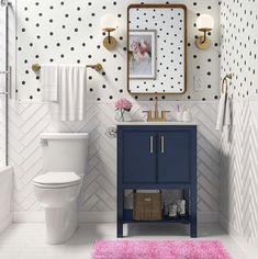 a bathroom with polka dot wallpaper and pink rugs on the floor next to the toilet